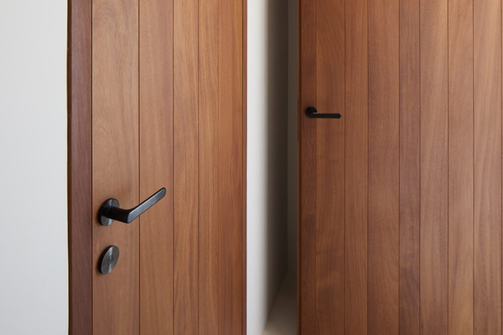 Puertas de madera natural con tiradores negros en diseño minimalista